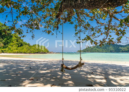 Wooden swing on beautiful white sand beach, Surin island national park, Phang nga, Thailand Wooden swing on beautiful white sand beach, Surin island national park, Phang nga, Thailand 93310022