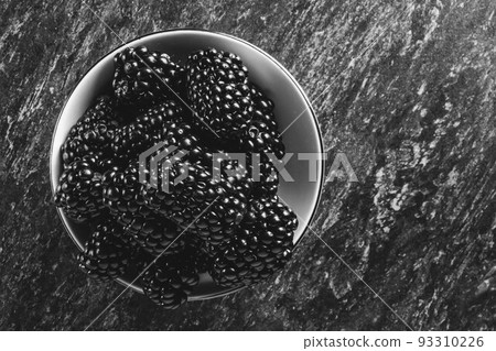 Blackberry berries. Black berries close-up on a wooden surface. Copyspace. 93310226