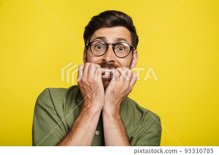 Afraid man biting nails with worry, frightened male looking at camera, having emotional stress, reacting to scary news Afraid man biting nails with worry, frightened male looking at camera, having emotional stress, reacting to scary news 93310785