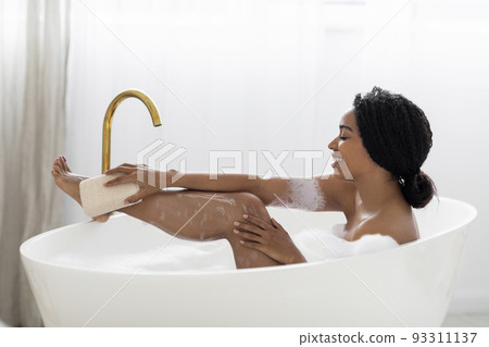 Beautiful Black Woman Taking Foamy Bath And Using Body Sponge 93311137