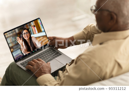 Remote Meeting. Senior Black Man Having Video Call With Young Female On Laptop Remote Meeting. Senior Black Man Having Video Call With Young Female On Laptop 93311212
