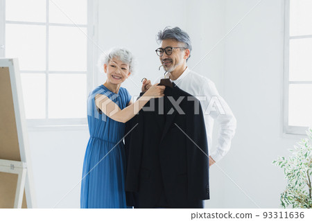Gray-haired couple choosing clothes Gray-haired couple choosing clothes 93311636