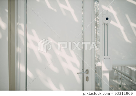 Face recognition system with camera in front of office in white interior indoor door 93311969