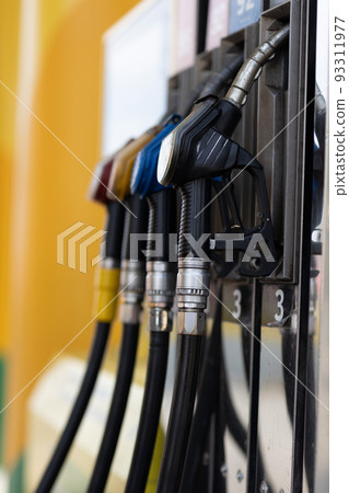 Close up filling gun in his hand at gas station. 93311977