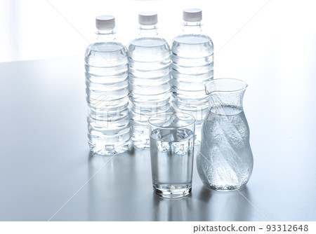 A cup and a plastic bottle on the table A cup and a plastic bottle on the table 93312648