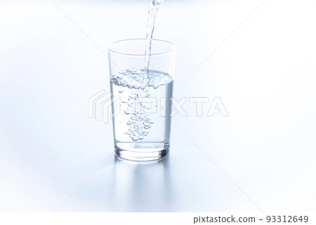pour water into a cup on the table pour water into a cup on the table 93312649