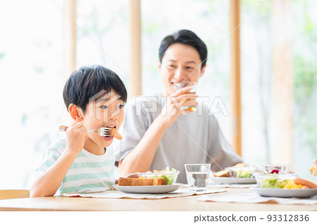 family having breakfast in the living room 93312836