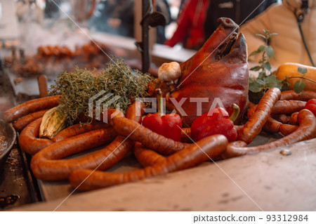 Fried baked sausages, hot dog on street food outdoor market stall in Krakow Poland Fried baked sausages, hot dog on street food outdoor market stall in Krakow Poland 93312984