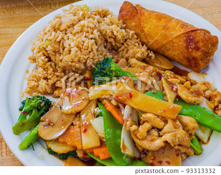 Close up shot of Hunan chicken with fried rice and egg roll Close up shot of Hunan chicken with fried rice and egg roll 93313332