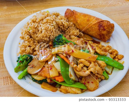 Close up shot of Hunan chicken with fried rice and egg roll 93313333