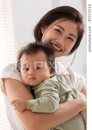 Happy asian mom playing and spending time with her newborn baby and looking at camera together at home.Adorable baby boy smile laughing with mother in warmth place relax and comfortable.good moment Happy asian mom playing and spending time with her newborn baby and looking at camera together at home.Adorable baby boy smile laughing with mother in warmth place relax and comfortable.good moment 93313514