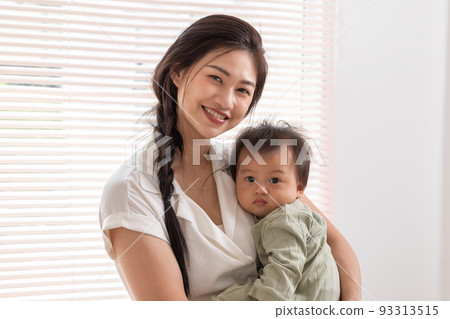 Happy asian mom playing and spending time with her newborn baby and looking at camera together at home.Adorable baby boy smile laughing with mother in warmth place relax and comfortable.good moment Happy asian mom playing and spending time with her newborn baby and looking at camera together at home.Adorable baby boy smile laughing with mother in warmth place relax and comfortable.good moment 93313515