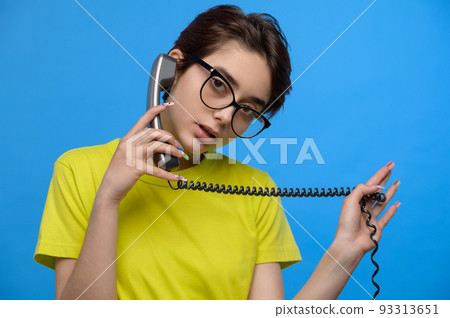 Cute young brunette girl having phone conversation Cute young brunette girl having phone conversation 93313651