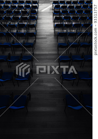 A photo of the blue chairs at the lecture hall, a specially blurred picture for the background, empty seats, deserted 93313757
