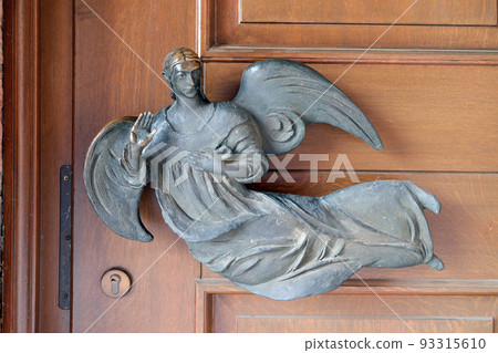 Angel on the door of the Saint Lawrence church in Kleinostheim, Germany Angel on the door of the Saint Lawrence church in Kleinostheim, Germany 93315610