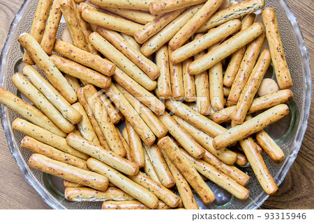Sticks of crispy bread with poppy seeds, texture for background. Sticks of crispy bread with poppy seeds, texture for background. 93315946