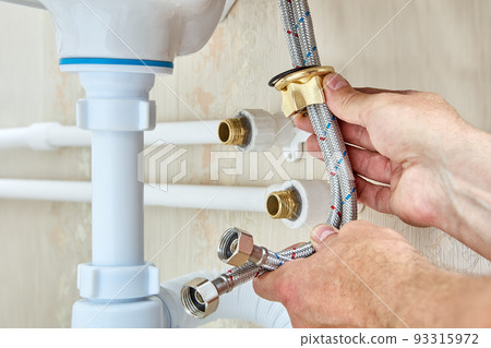 Connected faucet to sink by using braided water hoses and to home water supply during plumbing work. Connected faucet to sink by using braided water hoses and to home water supply during plumbing work. 93315972