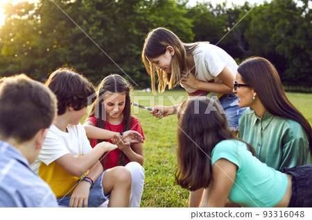 Group of happy little children playing games, dancing and having fun in the park Group of happy little children playing games, dancing and having fun in the park 93316048