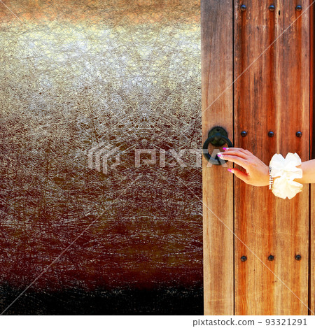 Hand to open the old wooden door Hand to open the old wooden door 93321291