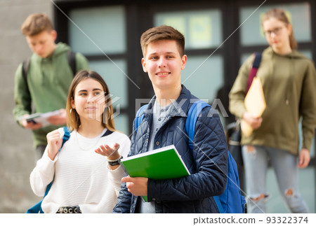 Carefree teen students boy and girl friendly talking 93322374