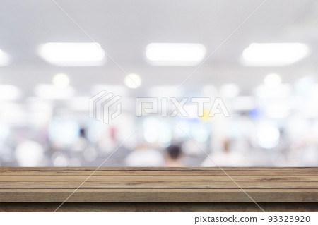Empty wooden table anb Abstract blur airport interior for backgounrd 93323920
