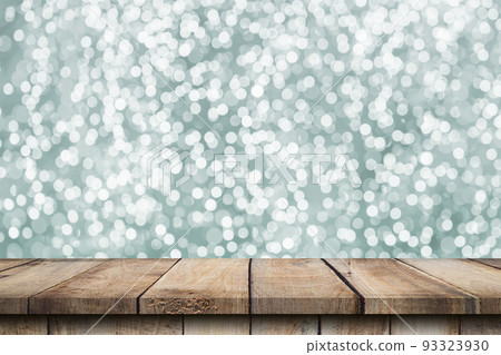 Abstract circular boken nigth and wood table for christmas background with space Abstract circular boken nigth and wood table for christmas background with space 93323930