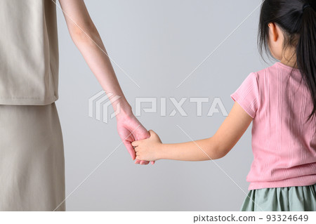 Parent and child holding hands Back view 93324649