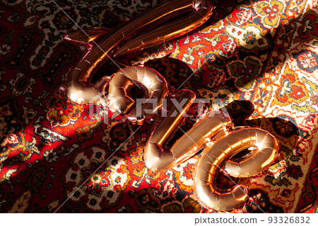 Love text pink foil balloon on authentic Love word from pink inflatable balloon laying carpet. Happy Valentines Day, Mother's Day, birthday concept. Minimalistic creative  93326832