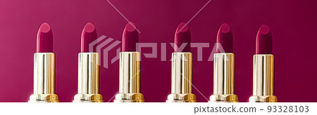 Purple lipsticks in golden tubes on colour background, luxury make-up and cosmetics for beauty brand product design concept Purple lipsticks in golden tubes on colour background, luxury make-up and cosmetics for beauty brand product design concept 93328103
