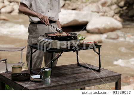 Asian woman journey and camping and making grill food. Travel outdoor activity lifestyle. Asian woman journey and camping and making grill food. Travel outdoor activity lifestyle. 93329037
