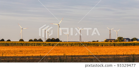 Wind farm in the field, wind turbines spin to generate electricity, alternative energy and green technology concept 93329477