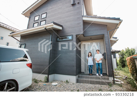 Asian couple/family standing at the entrance of a new house Asian couple/family standing at the entrance of a new house 93330218
