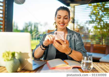 woman is working sitting on the patio 93330999