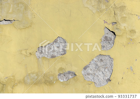 Damaged yellow plaster of a concrete wall 93331737