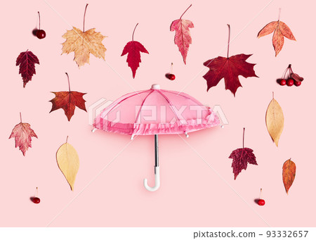 Falling autumn leaves and pink umbrella on pink pastel background. Hello Autumn creative concept Falling autumn leaves and pink umbrella on pink pastel background. Hello Autumn creative concept 93332657