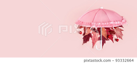 Autumn leaves fall from pink umbrella on pink pastel banner. Hello Autumn creative concept Autumn leaves fall from pink umbrella on pink pastel banner. Hello Autumn creative concept 93332664