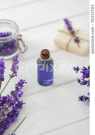 Lavender soap bars and spa products with lavender flowers on a white wooden table 93333563