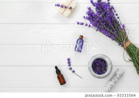 Lavender soap bars and spa products with lavender flowers on a white wooden table 93333564