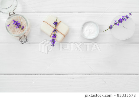 Lavender soap bars and spa products with lavender flowers on a white wooden table 93333578