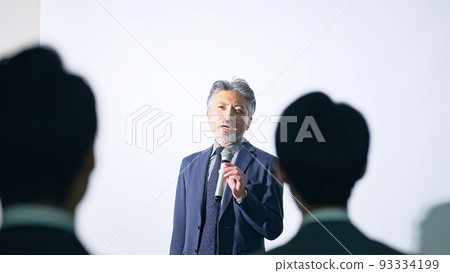Men on stage and audience seminar presentation 93334199