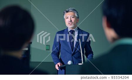 Men on stage and audience seminar presentation 93334204