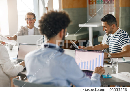 Group of young diverse coworkers analyzing sales report while working together in the office 93335358