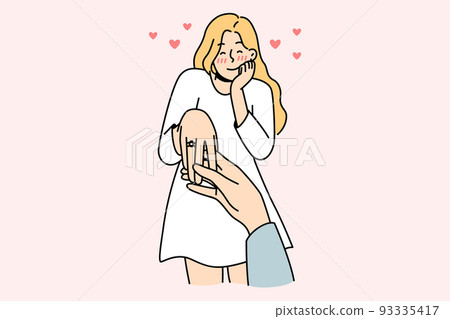 Happy woman with ring on finger Happy woman with ring on finger 93335417