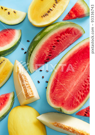 Top view of ripe juicy red and yellow watermelon slices over colorful background. Design for wallpaper, greeting season card. Closeup Top view of ripe juicy red and yellow watermelon slices over colorful background. Design for wallpaper, greeting season card. Closeup 93336743