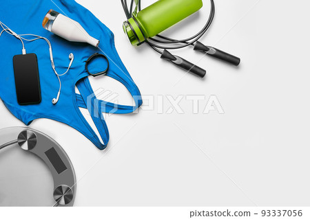 Sport, fitness, healthy lifestyle, cardio training and objects concept - close up of female sports clothing, skipping rope and bottle set 93337056