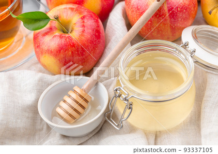 Jewish holiday Rosh Hashanah background with honey and apples on wooden table. Jewish holiday Rosh Hashanah background with honey and apples on wooden table. 93337105