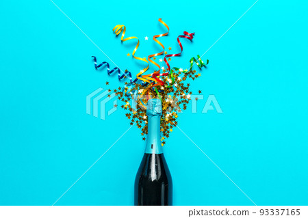 Champagne bottle with colorful party streamers Champagne bottle with colorful party streamers 93337165