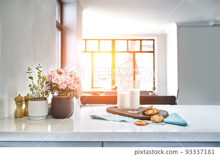 Cookies and Milk with an glass milk bottle on a kitchen counter for a after school snack of cookies and milk 93337181