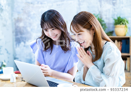 Two young women planning a trip Two young women planning a trip 93337234