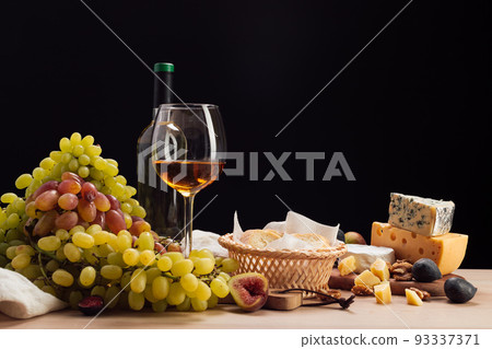 Wine and cheese on the table Wine and cheese on the table 93337371